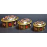 A set of three Royal Crown Derby 1128 pattern oval trinket boxes and covers