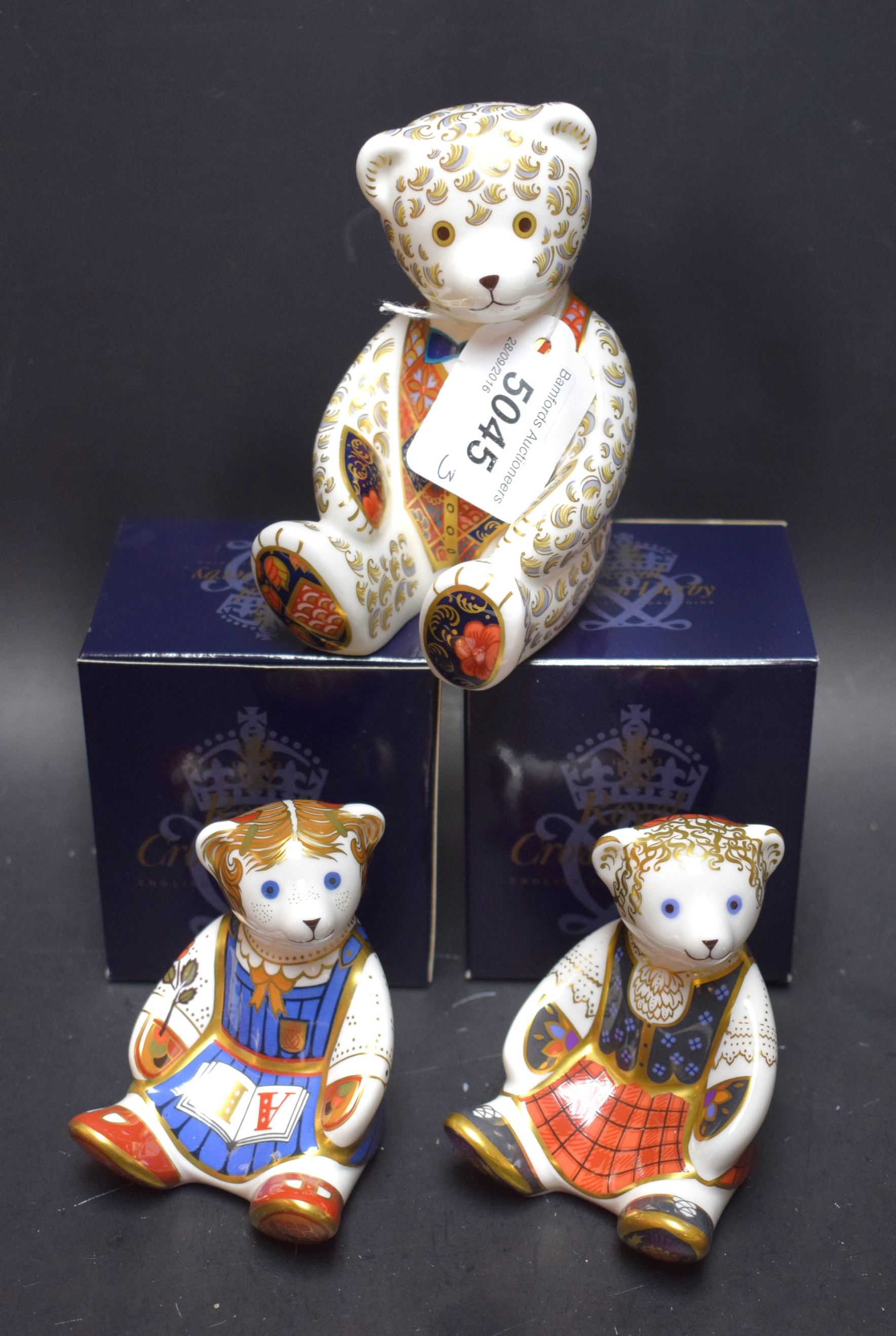 A Royal Crown Derby paperweight, Shona Bear, gold stopper, boxed; others, Schoolgirl Teddy,