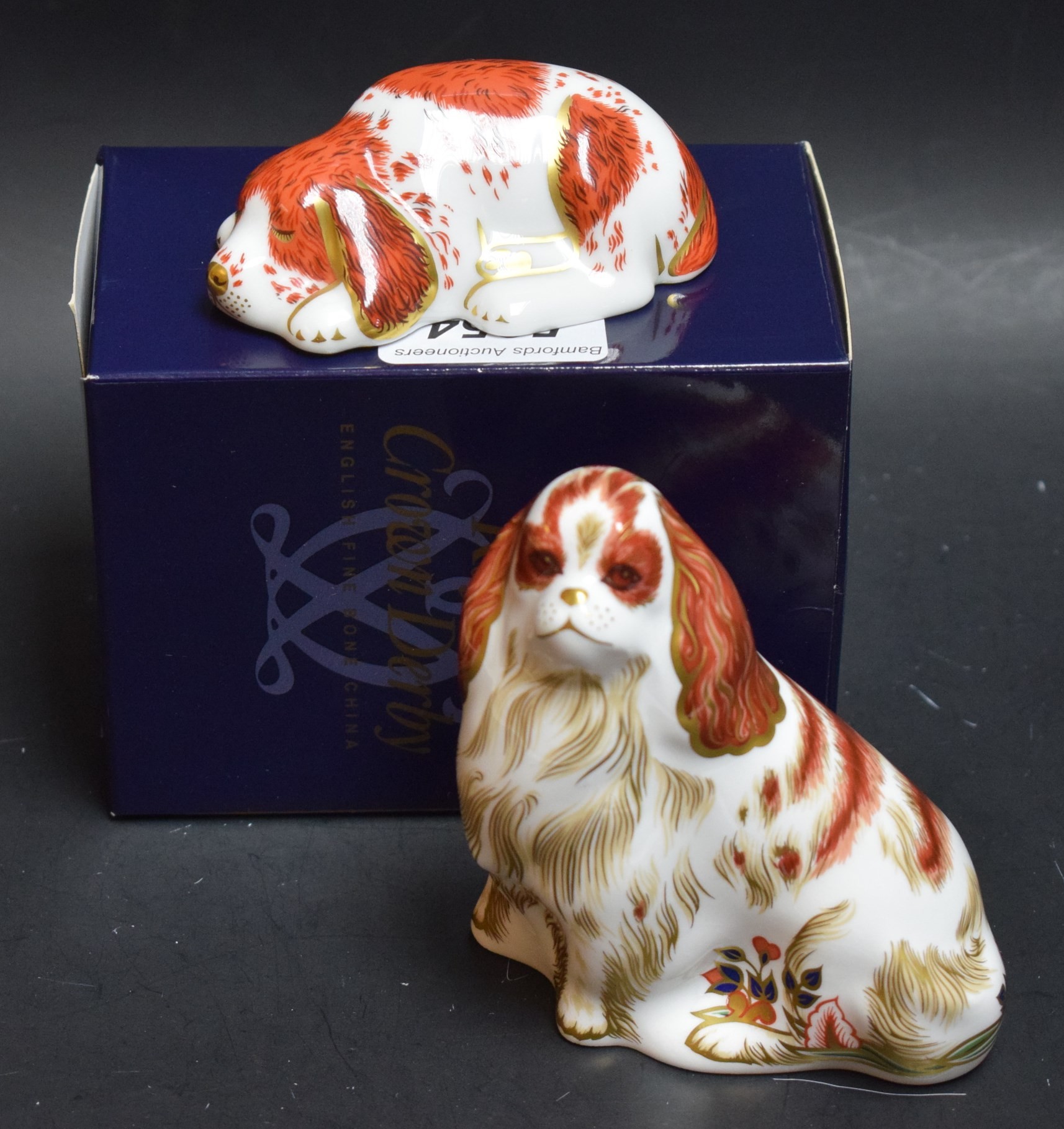 A Royal Crown Derby paperweight, Cavalier King Charles Spaniel, gold stopper, boxed; another, Puppy,