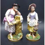 A pair of porcelain figures, of ladies, one with a pail, the other with dove, in colours,