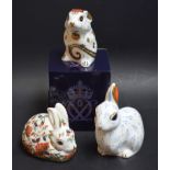 A Royal Crown Derby paperweight, Snowy Rabbit, designed by June Branscombe; others, Meadow Rabbit,