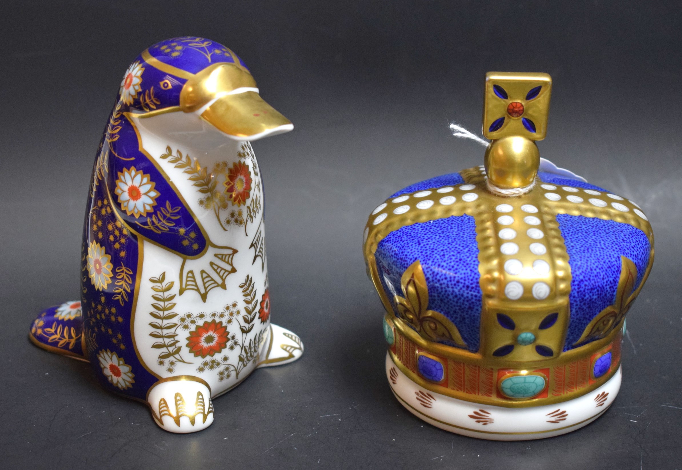 A Royal Crown Derby paperweight, Duck Billed Platypus, silver stopper, second; another,