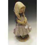 A Lladro figure of a Child standing deep in thought