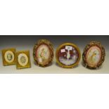 A pair of Continental porcelain ceramic plaques, painted and gilded with cherubs,