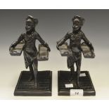 A pair of spelter figures in the form of Dickensian bread sellers.