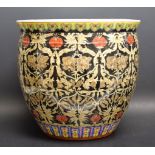 A Chinese ovoid jardiniere, painted in the famille noir palette with a ground of stylised flowers,