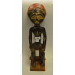 Tribal Art - an African carved hardwood seated figure