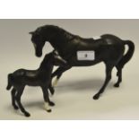 A Beswick Black Beauty mare and foal