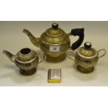 A silver coloured metal teapot,