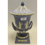 A Wedgwood blue jasper campana shaped vase and cover, typically sprigged in white,