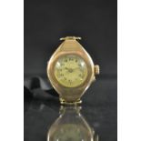 A vintage lady's 9ct gold wristwatch, oval case, round silvered dial, Arabic numerals, minute track,