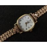 Omega - a lady's 9ct gold wristwatch, white dial, Roman numerals, minute track,