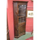 A Monastic oak floor standing corner cabinet,