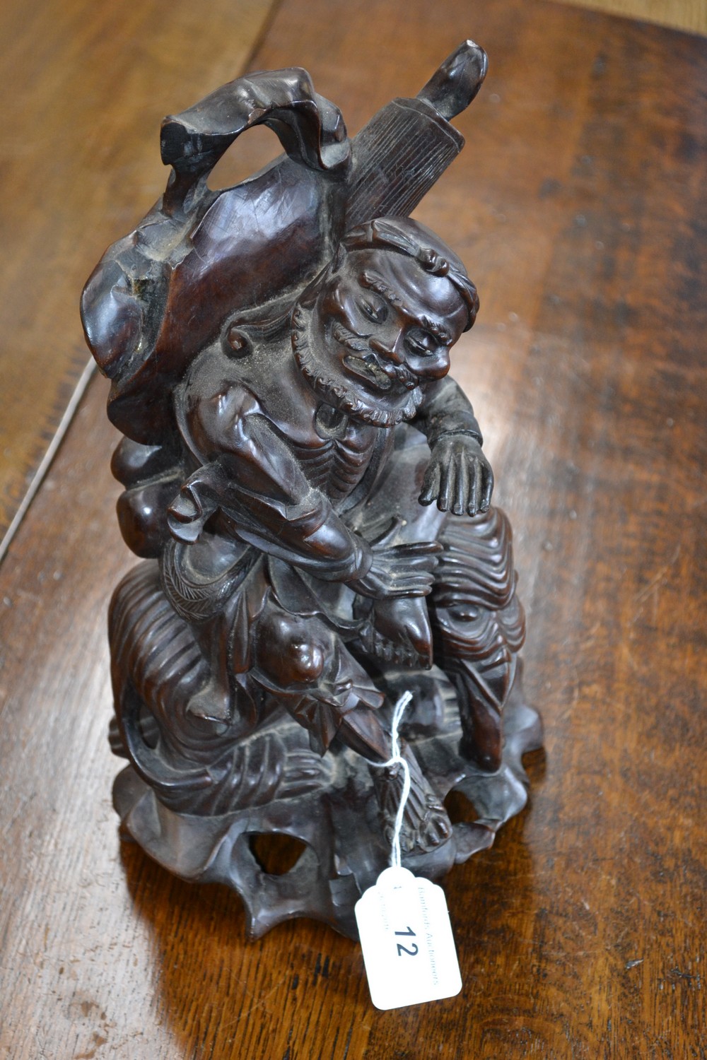 A Chinese hardwood carving, of a sage seated on an elephant, 31cm high,