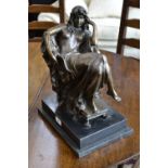 A bronze study of a seated nude on marble plinth.