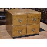 A mid 20th century oak desk top four drawer filing cabinet