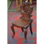 A Victorian mahogany hall chair, on carved cabriole legs,