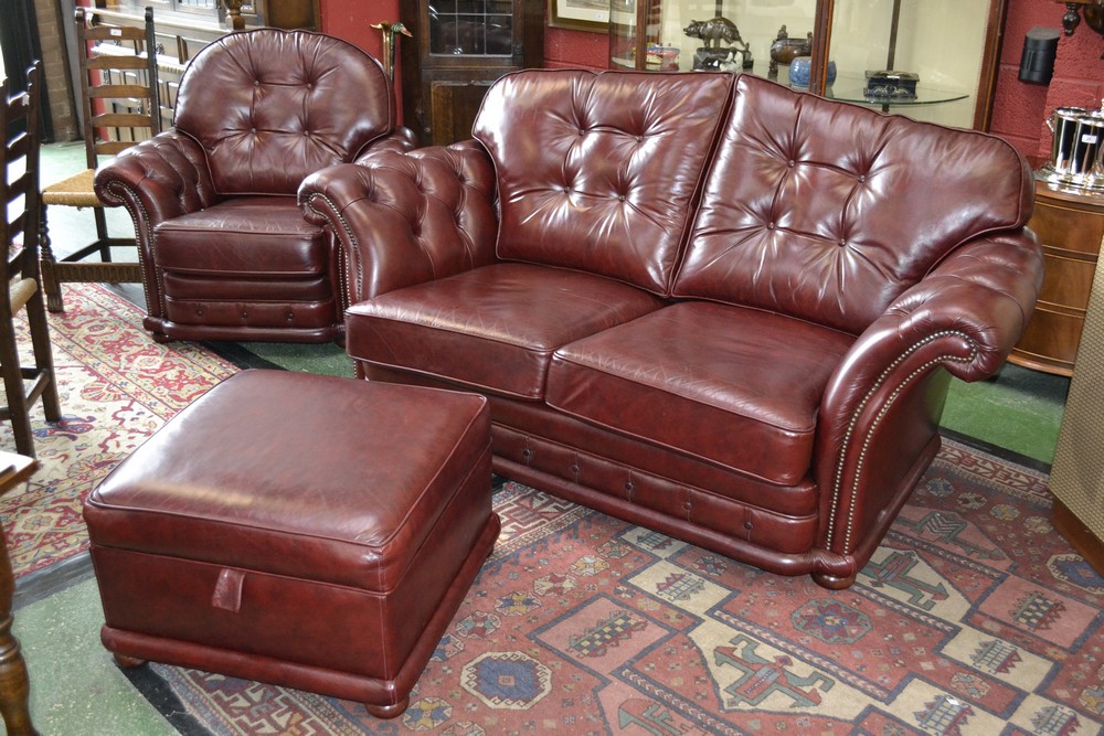 A late 20th century oxblood leather four piece suite,