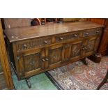 A Priory style oak sideboard, oversailing top,