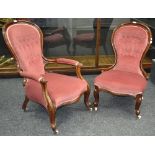 A pair of Victorian gentleman's and a lady's button upholstered spoon back salon chairs.