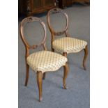 A pair of mahogany balloon back chairs, carved top rail and splat, stuffed overseat,