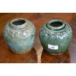 A pair of early Chinese green glazed wine pots