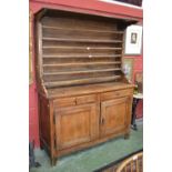 A 19th century French fruitwood dresser, projecting canopy above a seven-section plate rack,