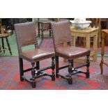 A pair of early 20th century Cromwellian style walnut chairs, brown leather back and seat,