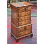 A small reproduction two tier chest of drawers