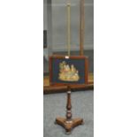 A Victorian pole screen, woolwork panel brass pole, turned mahogany column, triform base, bun feet.