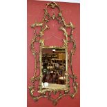 A large gilt framed wall mirror.