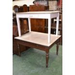 A Victorian pine table with Formica top, two single drawers, turned legs,