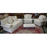 A contemporary four piece suite comprising three seat settee, wingback armchair,