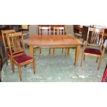 An Arts and Crafts style oak wind out dining table and five chairs, c.