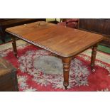 A Victorian mahogany wind out dining table with two leaf's,