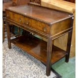 A mid-20th century walnut serving table, a pair of drawers, with brass swing handles,