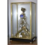 A cased skeleton clock, eagle finial, moon phase dial, Roman numeral outer chapter ring,