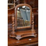 A Victorian mahogany dressing mirror, arched plate, turned finials, barley twist supports,
