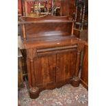 A William IV flame mahogany chiffonier, shaped pediment and shelf , tapering cylindrical supports,