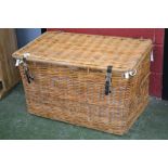 A large lined wicker hamper/log box