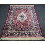 A red ground Kashmir rug, traditional medallion design.