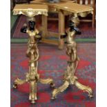 A pair of Blackamoor gilt tripod torcheres.