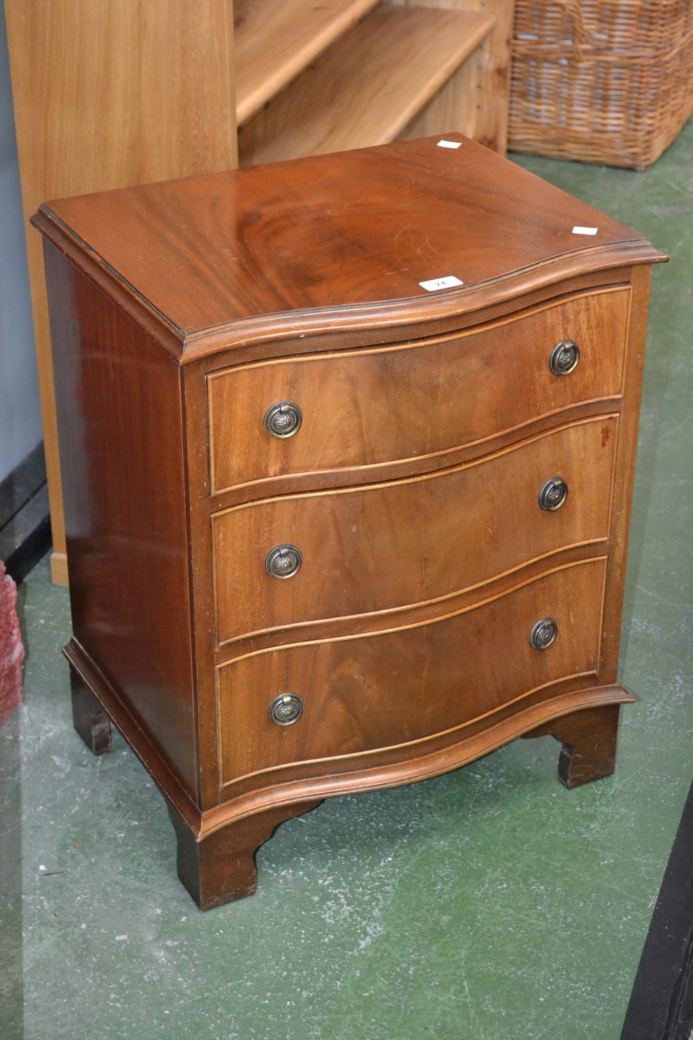 A small mahogany serpentine chest of drawers, Reprodux,