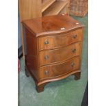 A small mahogany serpentine chest of drawers, Reprodux,