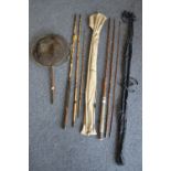 A bamboo fishing rod; two others; landing net.