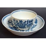 A Worcester porcelain tea bowl and saucer, decorated in underglaze blue, crescent mark, c.