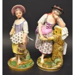 A pair of porcelain figures, of ladies, one with a pail, the other with dove, in colours,