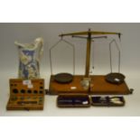 A set of brass balance scales and weights; a Moroccan leather cased necessaire,