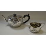 A silver bachelors teapot, wrythen fluted, 14cm high, London 1897; a similar sugar bowl,