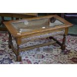 An Old Charm glass-top display coffee table